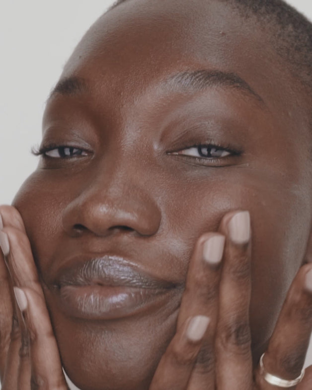 An array of ILIA skincare products being applied to models faces and being swatched. 