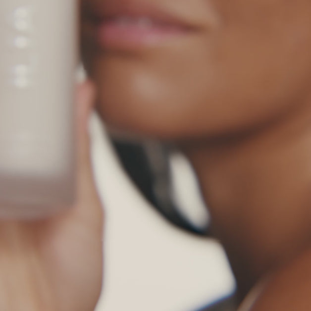 Models applying the ILIA Base Face Milk to their face with shots of it pouring in their hands.