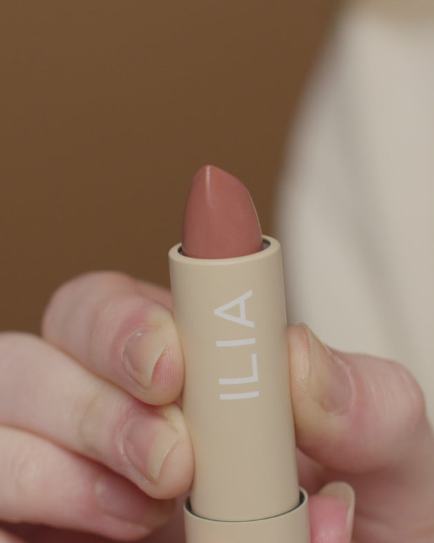 An assortment of ILIA lip products being applied to models lips.