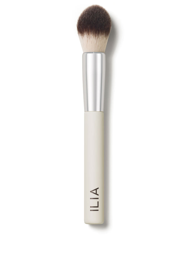 A close-up of the Precision brush with a white handle and dense, dual-toned bristles.