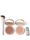 ILIA makeup essentials, featuring a sculpting brush, bronzer, highlighter, and blush stick, displayed on a white background.